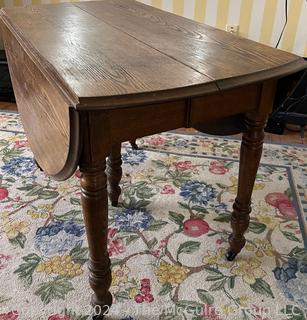 Five (5) Turned Legged Primitive Oak Drop Leaf Table. Measures 53w x 30h"