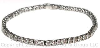 DeBeers Classic Eternity Line Round Brilliant Diamond Tennis Bracelet. It is composed of a single row of round brilliant-cut diamonds with a combined weight of approximately 5.79 carats. Each diamond is prong-set in 18K white gold.  7 ½” (19 cm) long.  Check retail price on DeBeers website.