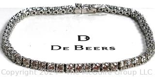 DeBeers Classic Eternity Line Round Brilliant Diamond Tennis Bracelet. It is composed of a single row of round brilliant-cut diamonds with a combined weight of approximately 5.79 carats. Each diamond is prong-set in 18K white gold.  7 ½” (19 cm) long.  Check retail price on DeBeers website.