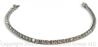 DeBeers Classic Eternity Line Round Brilliant Diamond Tennis Bracelet. It is composed of a single row of round brilliant-cut diamonds with a combined weight of approximately 5.79 carats. Each diamond is prong-set in 18K white gold.  7 ½” (19 cm) long.  Check retail price on DeBeers website.