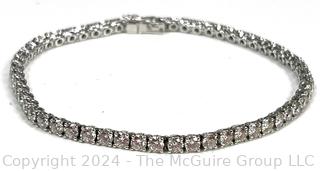 DeBeers Classic Eternity Line Round Brilliant Diamond Tennis Bracelet. It is composed of a single row of round brilliant-cut diamonds with a combined weight of approximately 5.79 carats. Each diamond is prong-set in 18K white gold.  7 ½” (19 cm) long.  Check retail price on DeBeers website.