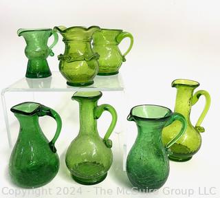 Seven (7) Pieces of Green Crackle Art Glass Pitchers.