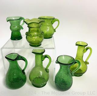 Seven (7) Pieces of Green Crackle Art Glass Pitchers.