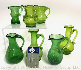 Seven (7) Pieces of Green Crackle Art Glass Pitchers.