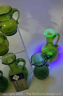 Seven (7) Pieces of Green Crackle Art Glass Pitchers.