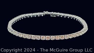 DeBeers Classic Eternity Line Round Brilliant Diamond Tennis Bracelet. It is composed of a single row of round brilliant-cut diamonds with a combined weight of approximately 5.79 carats. Each diamond is prong-set in 18K white gold.  7 ½” (19 cm) long.  Check retail price on DeBeers website.