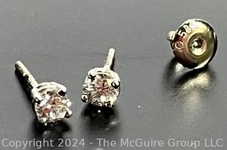 Pair of Round Brilliant Cut Natural Diamond Stud Earrings in Platinum Mounts, Totaling .46 Carats for the Pair. Includes International Gemological Appraisal dated 1999. Colorless (E-F) Clarity I(I). 3.5mm Missing one earring back.