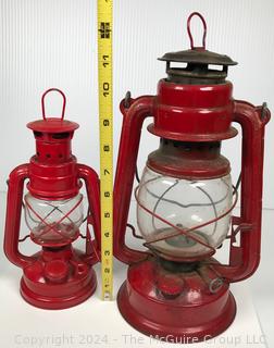 Two (2) Red Kerosene Lamps Including Globe No. 505 and World Light Lamp 