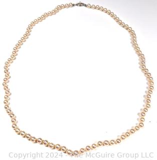 Opera Length Knotted Pearls with 14kt White Gold Clasp. 24" long.