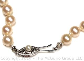 Opera Length Knotted Pearls with 14kt White Gold Clasp. 24" long.