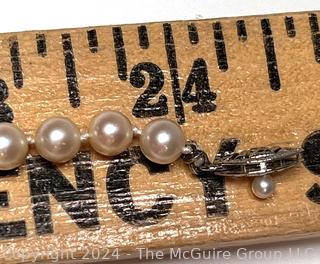 Opera Length Knotted Pearls with 14kt White Gold Clasp. 24" long.