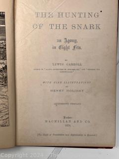 "The Hunting of the Snark: An Agony in Eight Fits" by Lewis Carroll. 

London: MacMillan and Co., 1876. xi,(3),83 pp. 12 mo. Dark Red Front and Rear Boards with Gilt Pictorial Illustrations by Henry Holiday. All edges gilt. Original black endpapers. Printed in London by R. Clay Sons & Taylor. Half title. One old ownership signature. Original plate tissue on Title Page. Last unnumbered leaf contains advertisements for Carrol's other works. A First Edition, this Issue Contains "Baker" for "Butcher" on p83. A fantastical poem involving a strange crew of tradesmen and a beaver as they set off on a journey to find "the Snark". 

1876 First Edition, 17th Printing of 1,000 {Description Updated 9/19/24 at 4:27pm ET}