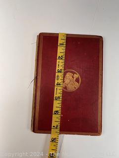 "The Hunting of the Snark: An Agony in Eight Fits" by Lewis Carroll. 

London: MacMillan and Co., 1876. xi,(3),83 pp. 12 mo. Dark Red Front and Rear Boards with Gilt Pictorial Illustrations by Henry Holiday. All edges gilt. Original black endpapers. Printed in London by R. Clay Sons & Taylor. Half title. One old ownership signature. Original plate tissue on Title Page. Last unnumbered leaf contains advertisements for Carrol's other works. A First Edition, this Issue Contains "Baker" for "Butcher" on p83. A fantastical poem involving a strange crew of tradesmen and a beaver as they set off on a journey to find "the Snark". 

1876 First Edition, 17th Printing of 1,000 {Description Updated 9/19/24 at 4:27pm ET}