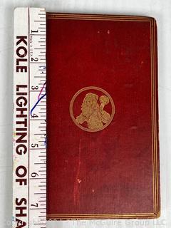 "The Hunting of the Snark: An Agony in Eight Fits" by Lewis Carroll. 

London: MacMillan and Co., 1876. xi,(3),83 pp. 12 mo. Dark Red Front and Rear Boards with Gilt Pictorial Illustrations by Henry Holiday. All edges gilt. Original black endpapers. Printed in London by R. Clay Sons & Taylor. Half title. One old ownership signature. Original plate tissue on Title Page. Last unnumbered leaf contains advertisements for Carrol's other works. A First Edition, this Issue Contains "Baker" for "Butcher" on p83. A fantastical poem involving a strange crew of tradesmen and a beaver as they set off on a journey to find "the Snark". 

1876 First Edition, 17th Printing of 1,000 {Description Updated 9/19/24 at 4:27pm ET}