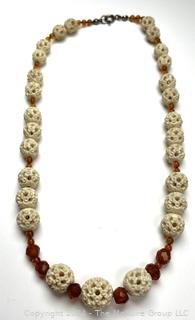 Faceted Amber and Pierced Bone Bead Necklace.  20" long