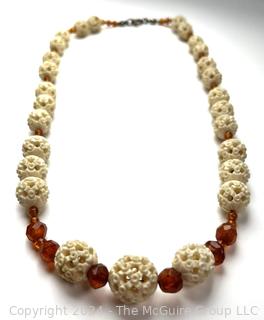 Faceted Amber and Pierced Bone Bead Necklace.  20" long