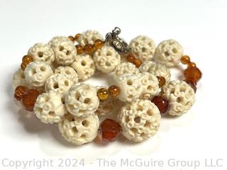 Faceted Amber and Pierced Bone Bead Necklace.  20" long