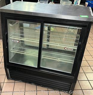 TRUE Refrigerated Mercandiser Cabinet with Slant Front Glass Sliding Doors in Front and Vertical Sliding Doors in Rear. Model 031D-48. Measures 48W x 29D x 50"T