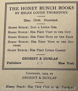 Two (2) Children's Books:  Honey Bunch: Her First Visit to The Seashore by Helen Louise Thorndyke and The Outdoor Girls of Deepdale by Laura Lee Hope