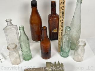 Nine (9) Glass Bottles and One (1) Glass Insulator