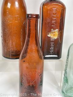 Nine (9) Glass Bottles and One (1) Glass Insulator