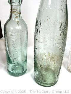 Nine (9) Glass Bottles and One (1) Glass Insulator