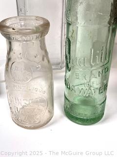 Nine (9) Glass Bottles and One (1) Glass Insulator