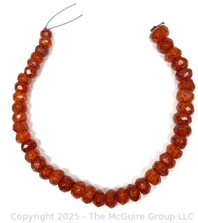 9" Strand of Carved Faceted Amber Beads. 