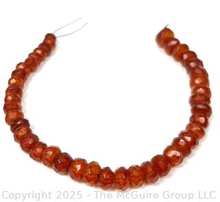 9" Strand of Carved Faceted Amber Beads. 