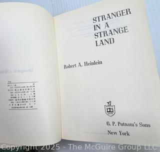 Eight (8) Books Including Stranger in a Strange Land. 