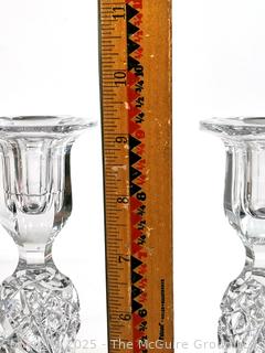 Pair of Cut Crystal Candlesticks. Small chip in base.  9" tall.