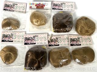 Selection of new doll wigs in original packaging 