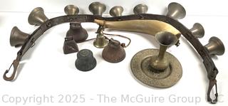 Grouping of brass bells and powder horn
