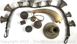 Grouping of brass bells and powder horn