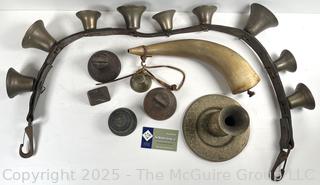 Grouping of brass bells and powder horn