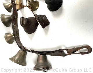 Grouping of brass bells and powder horn
