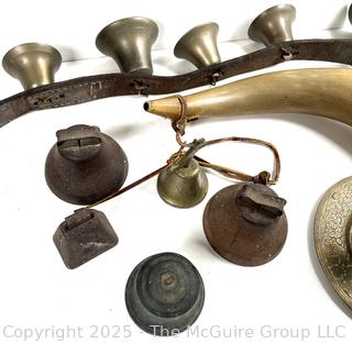 Grouping of brass bells and powder horn