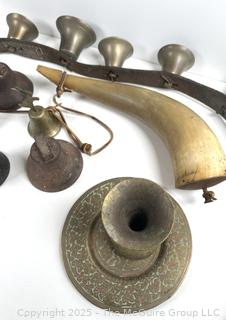 Grouping of brass bells and powder horn