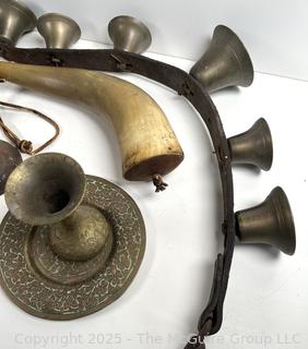 Grouping of brass bells and powder horn