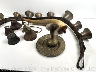 Grouping of brass bells and powder horn