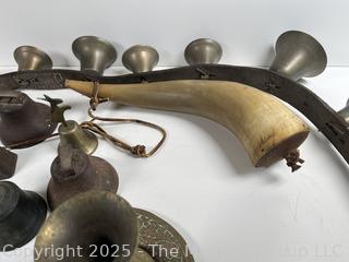 Grouping of brass bells and powder horn