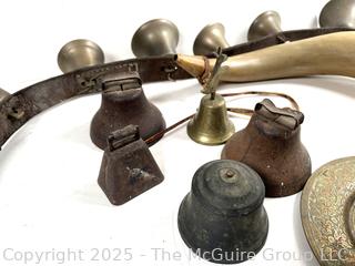 Grouping of brass bells and powder horn