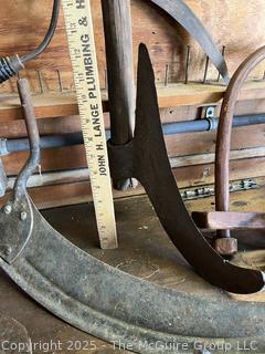 Grouping of Bench Tools Including Sickles, Hack Saw, Horse Bits, Hand Drill Brace and Large Axe Head  