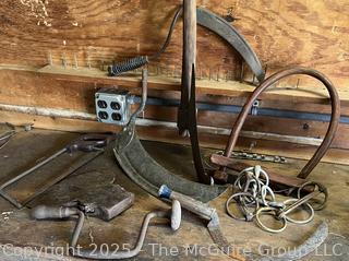 Grouping of Bench Tools Including Sickles, Hack Saw, Horse Bits, Hand Drill Brace and Large Axe Head  