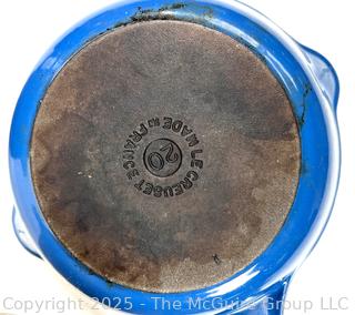 Cooking items: Vintage Le Winter Appliance Co Brushed Aluminum Hammered Dutch Oven 1930's; Le Creuset frying pan; and DRU Holland Blue Tulip Enameled Cast Iron Oval Baker Casserole Dish; blue ceramic creamer