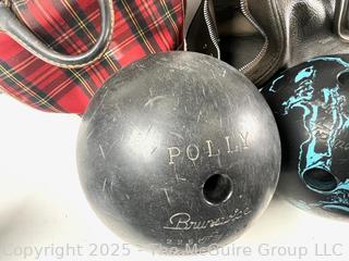 Two (2) vintage Brunswick Bowling balls with carrying bags