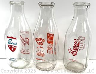 Group of three (3) antique glass milk bottles: various brands