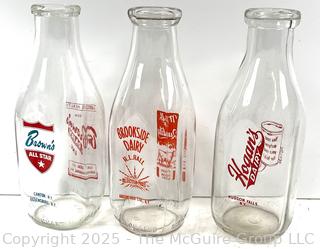 Group of three (3) antique glass milk bottles: various brands