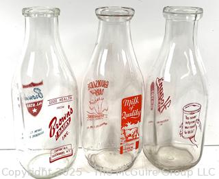 Group of three (3) antique glass milk bottles: various brands