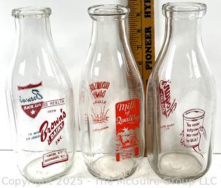 Group of three (3) antique glass milk bottles: various brands